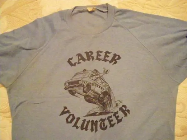A blue shirt with Career Volunteer and an ambulance graphic